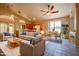Cozy living space featuring a comfortable sofa, chairs, a dining area, and a view into the kitchen at 20443 N 39Th Dr, Glendale, AZ 85308