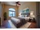 Comfortable bedroom featuring a plush bed, neutral decor, and a large window for natural light at 20443 N 39Th Dr, Glendale, AZ 85308