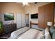 Cozy main bedroom featuring a ceiling fan, mounted TV, dresser and decor at 20443 N 39Th Dr, Glendale, AZ 85308