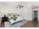 Comfortable bedroom with ceiling fan, wood-look tile flooring, neutral decor, and a spacious layout at 2137 E New Bedford Dr, Gilbert, AZ 85234