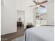 Primary bedroom featuring wood-look tile floors, ceiling fan, and en-suite bathroom at 2137 E New Bedford Dr, Gilbert, AZ 85234