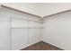 Walk-in closet with shelving and wood-look tile flooring, providing ample storage space at 2137 E New Bedford Dr, Gilbert, AZ 85234
