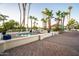 Community hot tub surrounded by lounge chairs and palm trees at 2137 E New Bedford Dr, Gilbert, AZ 85234