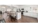 Modern kitchen featuring white cabinets, granite countertops, stainless steel appliances, and an open floor plan at 2137 E New Bedford Dr, Gilbert, AZ 85234