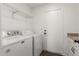 Well-lit laundry room with included washer and dryer, practical shelving and direct outdoor access at 2137 E New Bedford Dr, Gilbert, AZ 85234