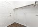Spacious walk-in closet features wood-look tile flooring and adjustable shelving for optimal storage and organization at 2137 E New Bedford Dr, Gilbert, AZ 85234