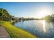 Beautiful waterfront homes with lush green lawns line the canal under a bright sunny sky at 2137 E New Bedford Dr, Gilbert, AZ 85234