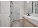Bathroom with glass enclosed shower, wood vanity and toilet at 2203 E Crest Ln, Phoenix, AZ 85024