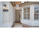 Close-up of the front door and sidelight window, showcasing modern lighting fixtures at 2203 E Crest Ln, Phoenix, AZ 85024