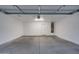 Spacious two-car garage with high ceilings, freshly painted walls, and ample storage space at 2203 E Crest Ln, Phoenix, AZ 85024