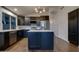 Modern kitchen featuring dark cabinets, stainless steel appliances, countertops, and wood-look tile flooring at 2203 E Crest Ln, Phoenix, AZ 85024