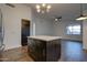 Modern kitchen featuring dark island with countertop, storage drawers and cabinets, and wood-look tile flooring at 2203 E Crest Ln, Phoenix, AZ 85024