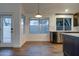Modern kitchen featuring dark cabinets, stainless steel appliances, countertops, and wood-look tile flooring at 2203 E Crest Ln, Phoenix, AZ 85024