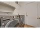 Laundry room featuring modern washer and dryer units and cabinet storage at 2203 E Crest Ln, Phoenix, AZ 85024