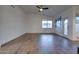 Spacious living room featuring high ceilings, neutral walls, wood-look tile flooring, and bright windows at 2203 E Crest Ln, Phoenix, AZ 85024