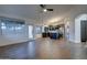 Open concept living room featuring dark cabinets, stainless steel appliances, and wood-look tile flooring at 2203 E Crest Ln, Phoenix, AZ 85024
