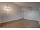 Spacious living area featuring wood-look tile, high ceilings, modern lighting, and neutral walls at 2203 E Crest Ln, Phoenix, AZ 85024