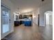 Open concept living room featuring dark cabinets, stainless steel appliances, and wood-look tile flooring at 2203 E Crest Ln, Phoenix, AZ 85024