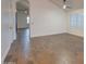 Bright living room featuring wood-look tile flooring, white walls, and plantation shutters at 2203 E Crest Ln, Phoenix, AZ 85024