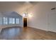 Bright and airy living room with wood-look tile flooring, a chandelier, and ample natural light at 2203 E Crest Ln, Phoenix, AZ 85024