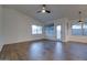 Spacious living room featuring neutral walls, wood-look tile flooring, bright windows, and a ceiling fan at 2203 E Crest Ln, Phoenix, AZ 85024