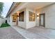 Covered patio with textured concrete, exterior door, tan stucco walls, and tile roof at 2203 E Crest Ln, Phoenix, AZ 85024