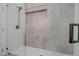 Close up of shower featuring stone subway tile at 2203 E Crest Ln, Phoenix, AZ 85024