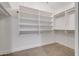 Organized walk-in closet with ample shelving and hanging space at 2203 E Crest Ln, Phoenix, AZ 85024