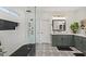 Luxurious bathroom featuring a tiled shower, designer tiles and a gray vanity at 3123 E Buena Vista Dr, Chandler, AZ 85249