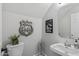 This powder bathroom has a commode, sink, and modern decor at 3123 E Buena Vista Dr, Chandler, AZ 85249