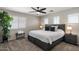 This primary bedroom has a ceiling fan, carpet, and natural light at 3123 E Buena Vista Dr, Chandler, AZ 85249