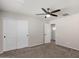 Comfortable bedroom with carpeted floors, ceiling fan, closet, and white doors leading to other rooms at 3123 E Buena Vista Dr, Chandler, AZ 85249