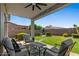 Relaxing covered patio seating area with ceiling fan overlooking a well-manicured backyard at 3123 E Buena Vista Dr, Chandler, AZ 85249