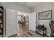 View through open double doors shows a dining room with exposed brick wall and farmhouse chandelier at 3123 E Buena Vista Dr, Chandler, AZ 85249