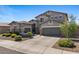 Attractive house featuring a three-car garage, stone accents, and low maintenance landscape at 3123 E Buena Vista Dr, Chandler, AZ 85249
