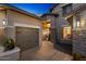 Close up of a three-car garage with stone pillar and walkway to front entrance at 3123 E Buena Vista Dr, Chandler, AZ 85249