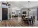 Open-concept living and dining area with wood floors, a fireplace and plentiful seating at 3123 E Buena Vista Dr, Chandler, AZ 85249