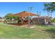 Community playground featuring shade coverings, benches, and well-maintained green space on a sunny day at 3123 E Buena Vista Dr, Chandler, AZ 85249