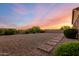 Expansive backyard with gravel landscaping, a paved walkway, and desert shrubs at 31502 N 58Th Pl, Cave Creek, AZ 85331