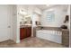 Modern bathroom with a soaking tub, granite countertops, tile floors, and wood cabinetry at 31502 N 58Th Pl, Cave Creek, AZ 85331
