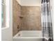 Bright bathroom showcasing a shower-tub combo and neutral colored tile at 31502 N 58Th Pl, Cave Creek, AZ 85331