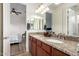Bathroom with granite-topped double vanity and view into adjacent bedroom at 31502 N 58Th Pl, Cave Creek, AZ 85331