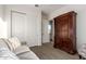 Bedroom featuring a dark wood armoire and closet with neutral walls at 31502 N 58Th Pl, Cave Creek, AZ 85331