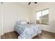 Cozy bedroom showcasing a queen bed with floral bedding and a sunny window view at 31502 N 58Th Pl, Cave Creek, AZ 85331