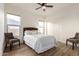 Charming bedroom with wood floors, two windows, and decorative chairs flanking a bed at 31502 N 58Th Pl, Cave Creek, AZ 85331