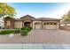 Stunning single-story home featuring stone accents, manicured landscaping, and a three-car garage at 31502 N 58Th Pl, Cave Creek, AZ 85331