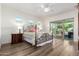 Bright main bedroom features hardwood floors, natural light, a ceiling fan, and access to the backyard at 31502 N 58Th Pl, Cave Creek, AZ 85331