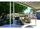 Charming backyard patio with stone walkway, garden and mature trees at 3202 W Joan De Arc W Ave, Phoenix, AZ 85029
