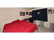 Cozy bedroom featuring a red bedspread, desk with chair, and dark blue curtains at 3202 W Joan De Arc W Ave, Phoenix, AZ 85029