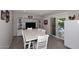 Cozy dining room with a wooden table, modern furnishings, and a sliding door to the backyard at 3202 W Joan De Arc W Ave, Phoenix, AZ 85029